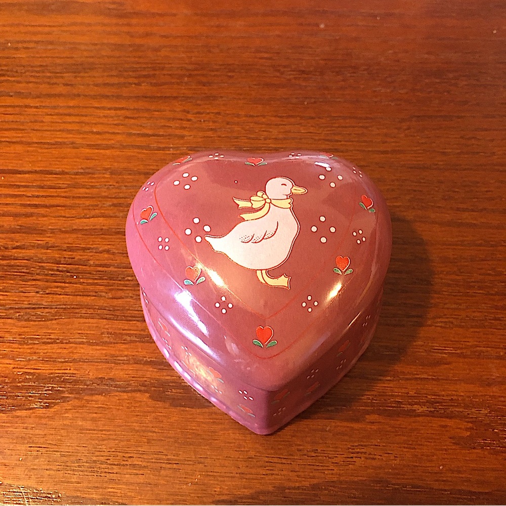 Red ceramic heart shaped trinket box with a duck.